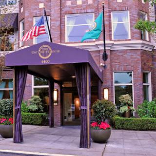 The welcoming entrance of a charming hotel with flags displayed prominently.