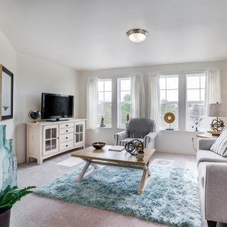 A bright and modern living room with stylish furniture and decor.