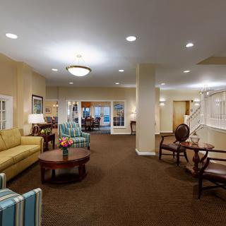 A well-lit lobby features comfortable seating and elegant decor.