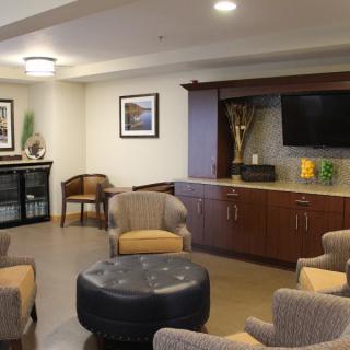 A cozy lounge area with comfortable seating and a television.