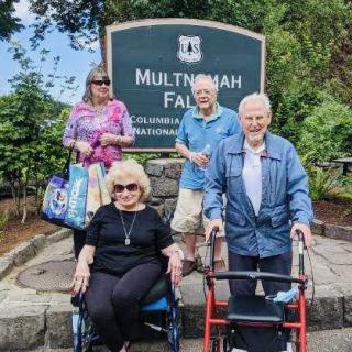 A group of seniors visiting Multnomah Falls, enjoying an outdoor excursion.