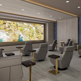 A modern home theater with luxury seating and a large screen.