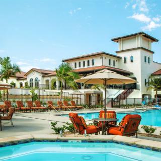 A luxurious resort featuring multiple swimming pools and elegant outdoor seating.