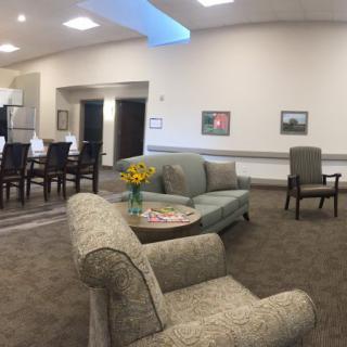 A cozy living room with comfortable seating and floral decor.