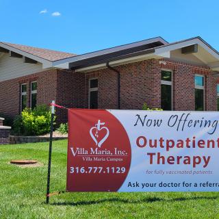 A healthcare facility sign advertising outpatient therapy services.