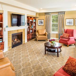 A cozy living room with a fireplace, television, and comfortable seating.