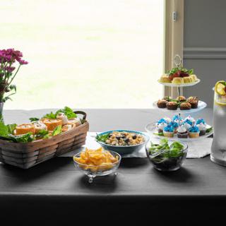 A beautifully arranged spread of snacks, salads, and desserts perfect for a gathering.