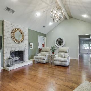 Modern living room with a vaulted ceiling, featuring a cozy fireplace and comfortable seating.