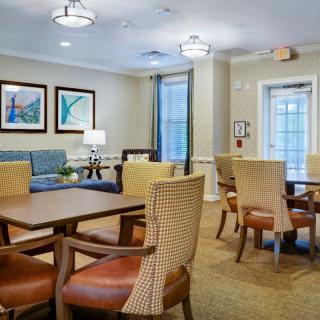 A cozy dining and living area with elegant furniture and warm lighting.