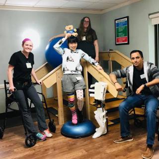 A supportive therapy session featuring a team of professionals assisting a patient in rehabilitation.