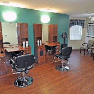 A well-organized hair salon featuring stylish chairs and mirrors, perfect for hair styling services.