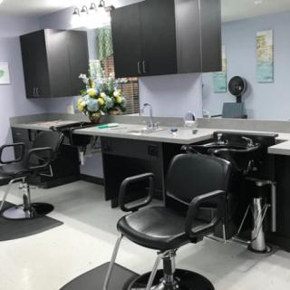 A neatly arranged hair salon with styling chairs and mirrors.
