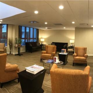 A modern lobby area featuring comfortable seating and warm lighting.
