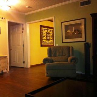 Cozy living room with an armchair and warm lighting.