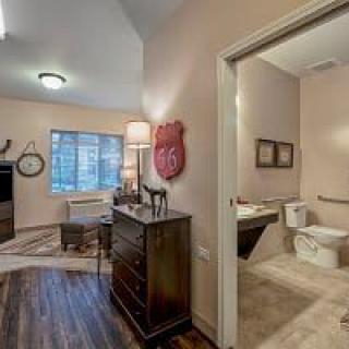 A view of a well-furnished bedroom with an adjoining bathroom.