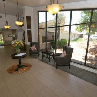 A modern lobby with large windows, comfortable seating, and elegant lighting.