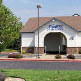 A small bank building with a drive-through, situated in a landscaped area with trees and a parking lot.