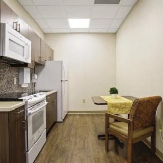 A compact kitchen area with modern appliances and a small dining table.