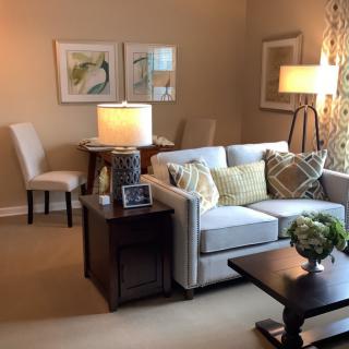 A cozy living room with a sofa, side table, and lamps.