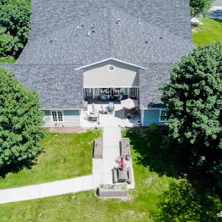 Aerial view of a spacious home with a well-maintained garden and walkway.