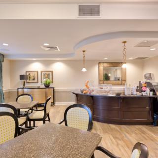 A cozy cafe interior with seating and a counter.