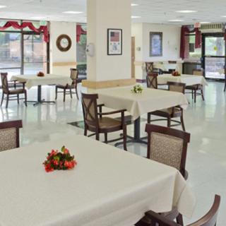 A spacious dining area with decorated tables and holiday-themed decor.