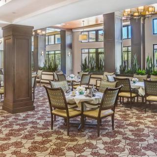 An elegant restaurant interior with tables and chairs set for dining.