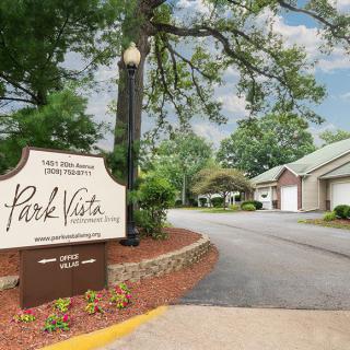Entrance to Park Vista with a welcoming sign and landscaped driveway.