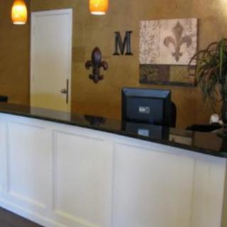 A reception area with a stylish desk and decorative elements on the wall.