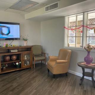 A cozy living room with a television, comfortable seating, and stylish decor.