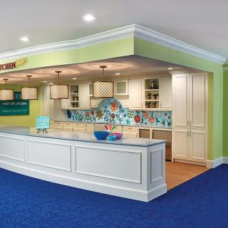 A modern and colorful kitchen with a spacious counter area and bright lighting.
