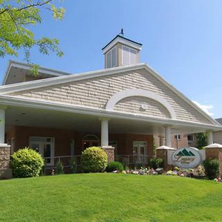 A well-maintained residential building with neatly landscaped surroundings and a prominent entrance.