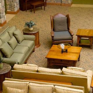 A cozy living room setup featuring sofas, a coffee table, and an armchair.