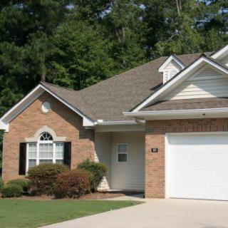 A suburban house with a brick exterior and attached garage.