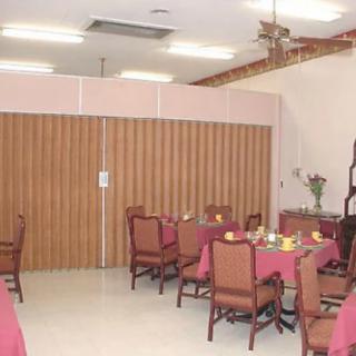 A dining area with several tables and chairs, set up for a meal.