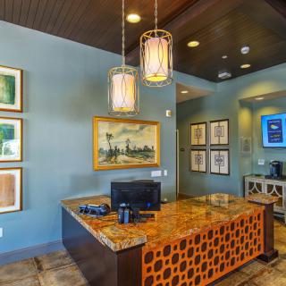 A modern reception area with stylish decor and a computer on the desk.