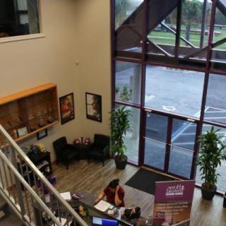 A view of a modern office lobby with a reception desk and waiting area.