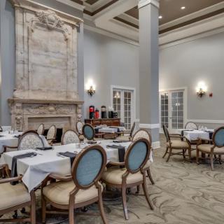 An elegant dining room with beautifully set tables and classic decor.