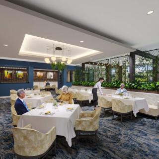 A modern restaurant interior with elegantly set tables, plush seating, and greenery accents.