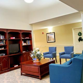 A cozy living room featuring a bookshelf, television, and comfortable seating.