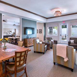 A modern living room with comfortable seating, a large TV, and stylish decor.
