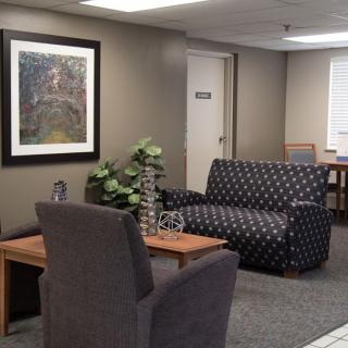 A cozy waiting room with comfortable seating and decor.