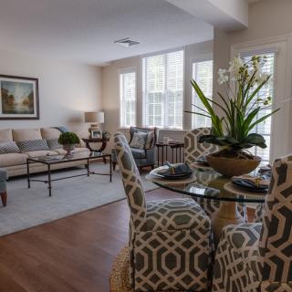 A modern living and dining area with stylish decor and bright natural lighting.