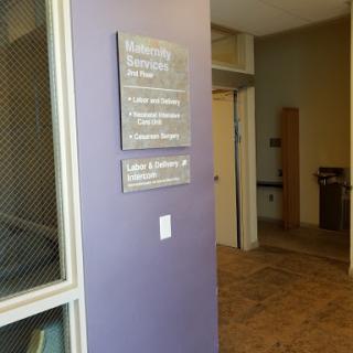 A glimpse of an office interior with a prominent purple wall and signage.
