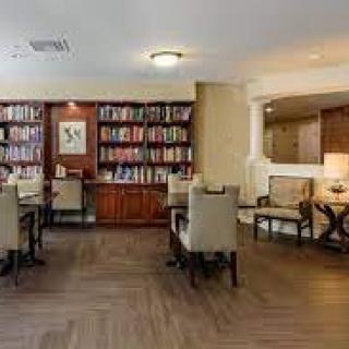 A cozy library space with bookshelves and a seating area.