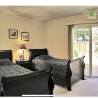 Cozy bedroom with twin beds and ample natural light.