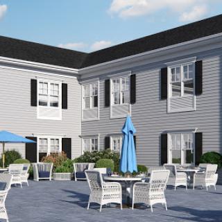 A serene courtyard area featuring outdoor seating and tables, perfect for relaxation.