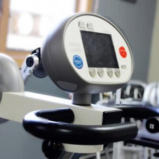 A close-up view of a stationary bike console in a gym.