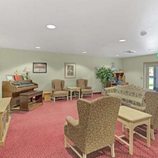 A comfortable living room with ample seating, an organ, and tasteful decor.