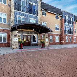 Front view of a modern hotel entrance with brick facade.